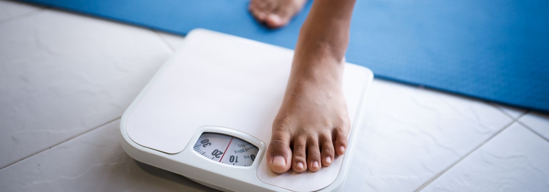 woman getting on scales