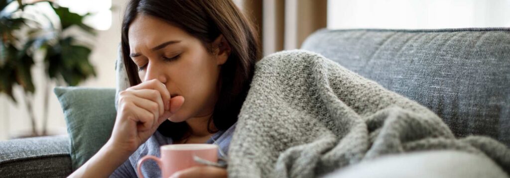 woman coughing COVID